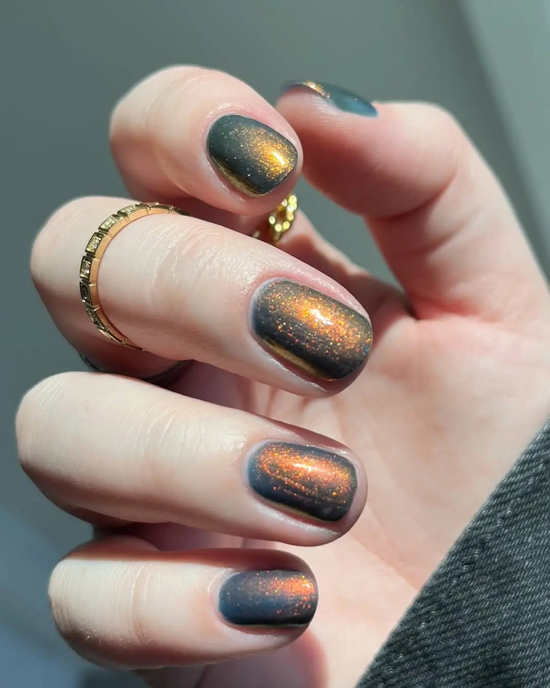Glistening nails with a dark, sparkly shimmer.