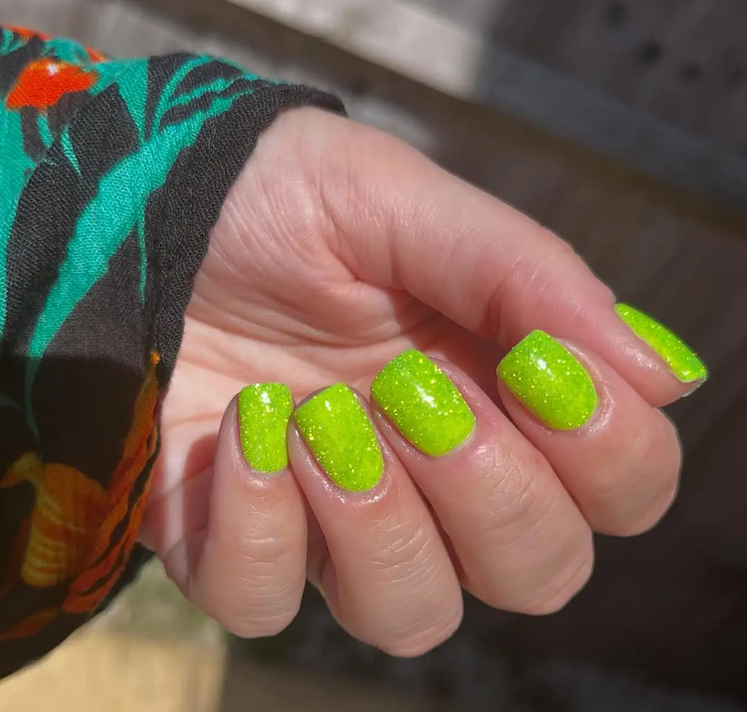 Vibrant green glitter nails for a fun vibe