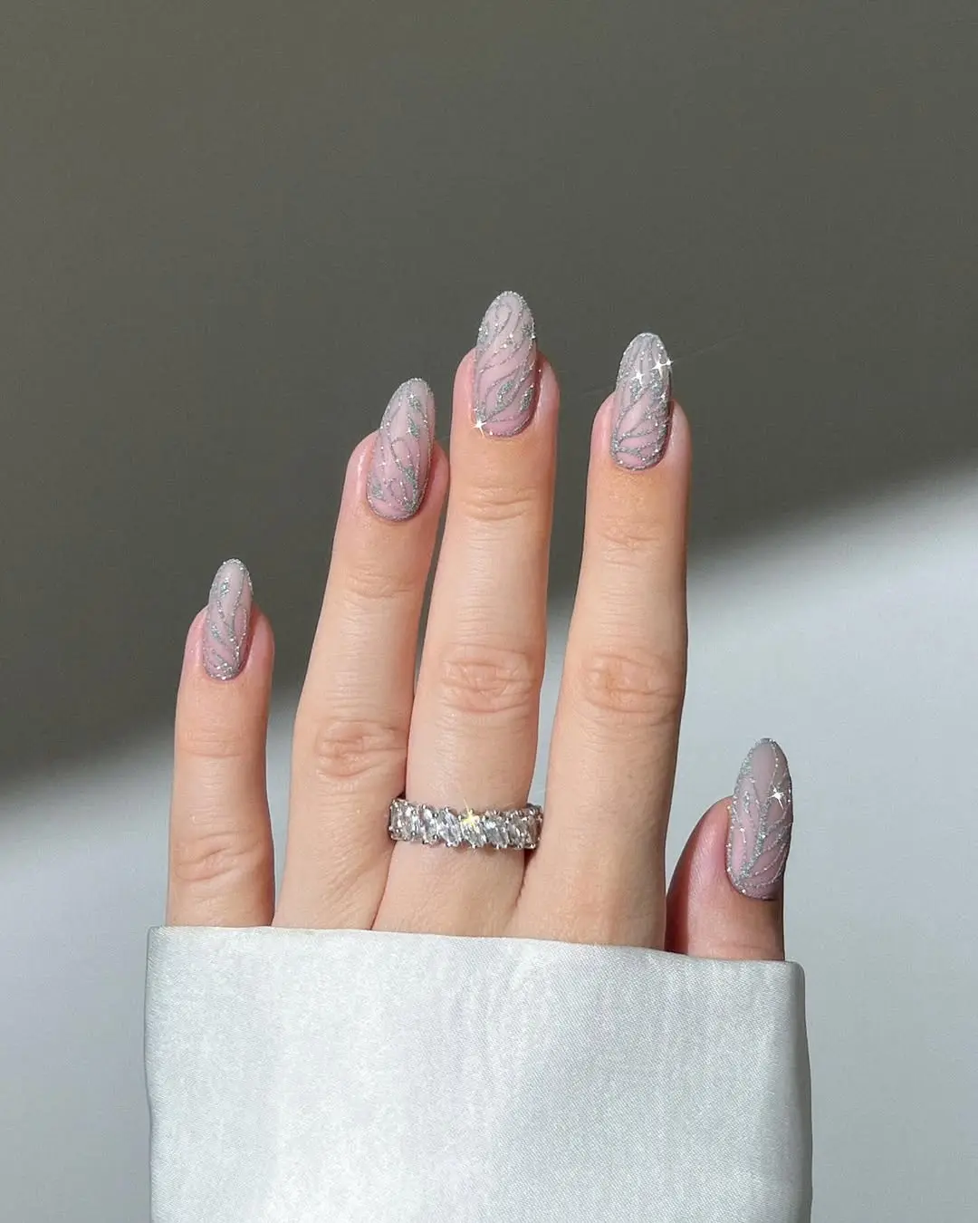 Elegant pink sparkly nails with silver accents