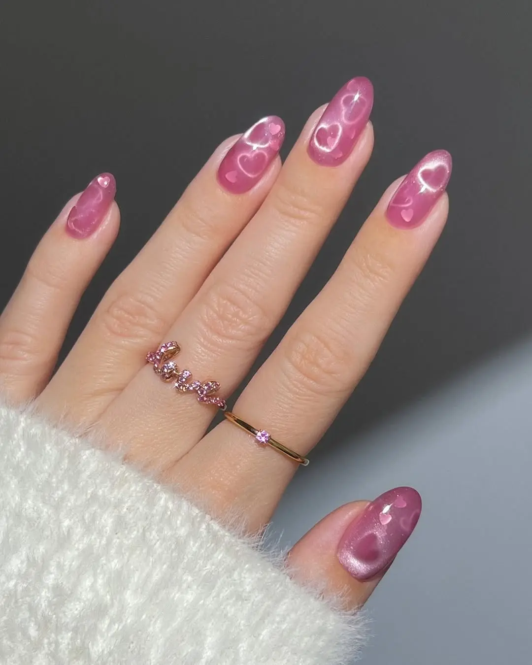 Charming sparkly pink nails with heart accents