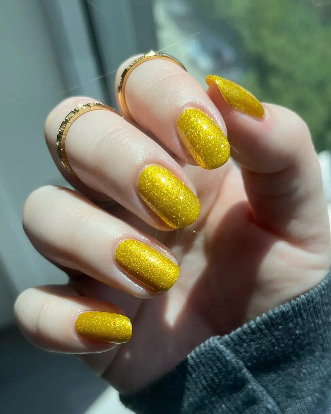 Vibrant sparkly yellow nails for a sunny vibe