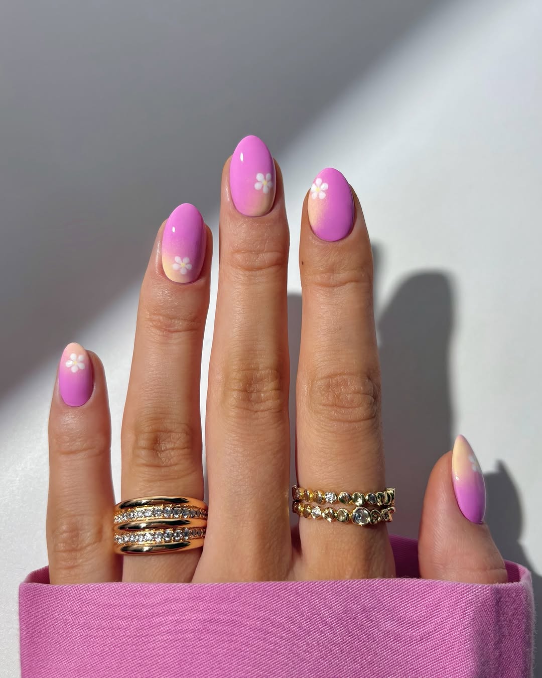 Vibrant pink nails with floral accents