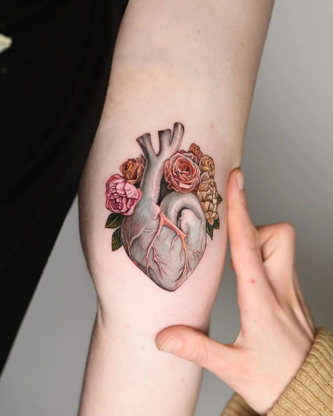 Stunning 3D heart tattoo with floral elements
