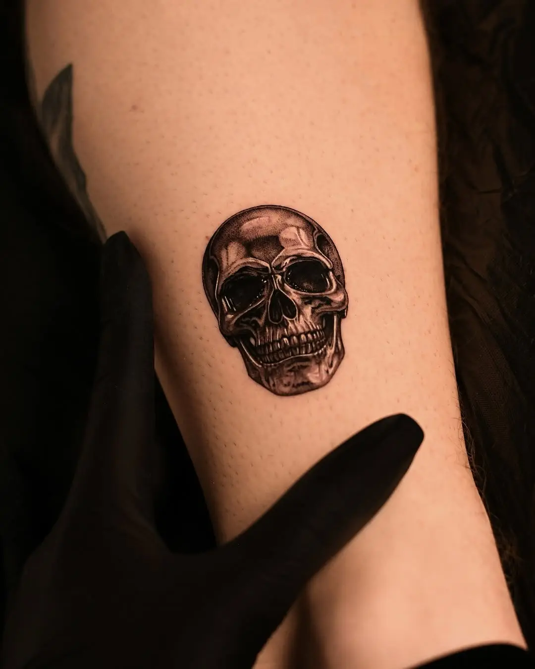 Intricate 3D skull tattoo design on arm