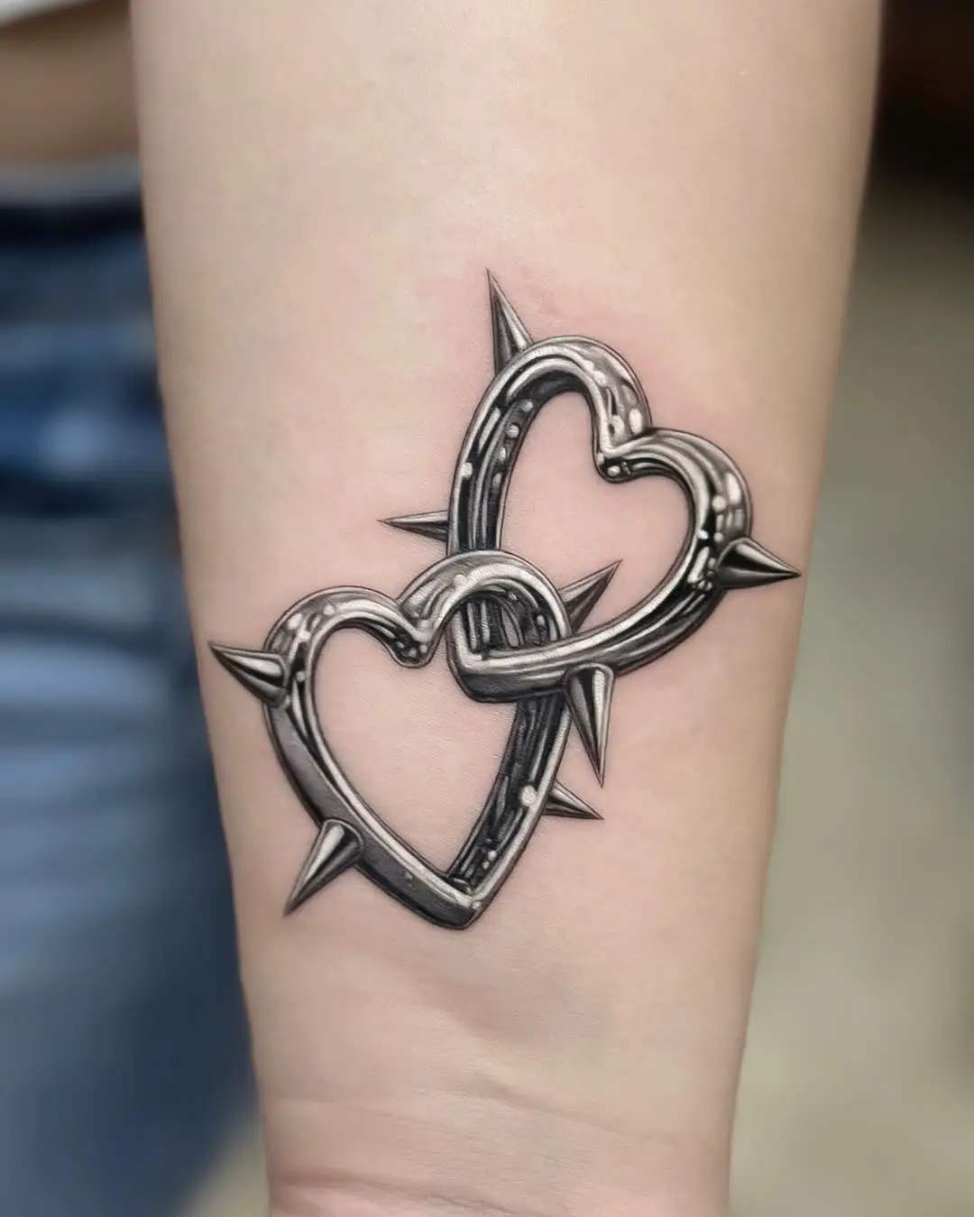 Intricate spiked hearts tattoo bursting with detail