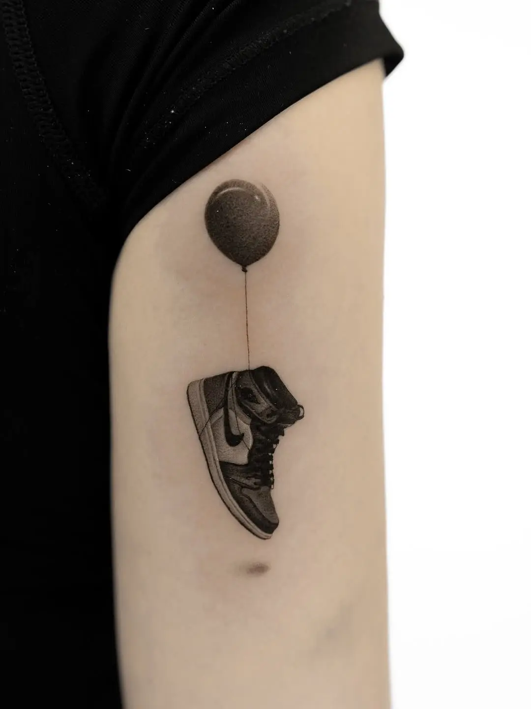 Unique sneaker tattoo with playful balloon design