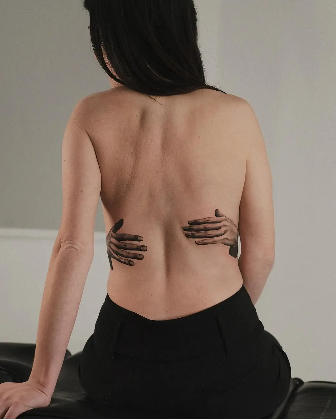 Unique 3D hands tattoo on back