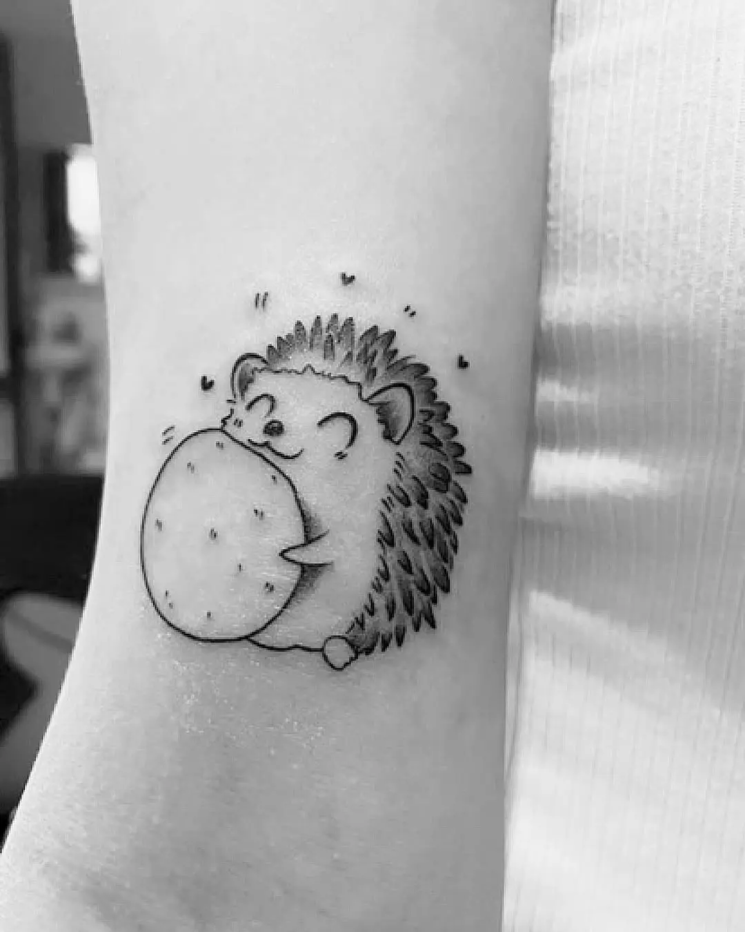 Cute hedgehog tattoo with playful cookie design