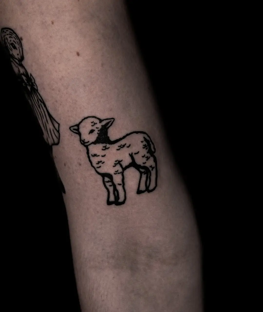 Charming lamb tattoo in minimalist style