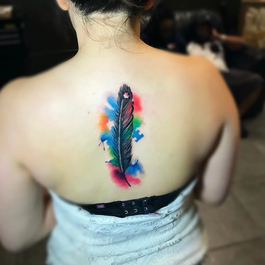 Colorful feather tattoo celebrating autism awareness