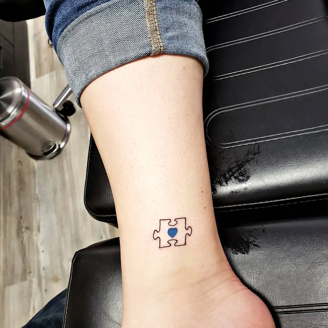 Stylish puzzle piece tattoo with heart