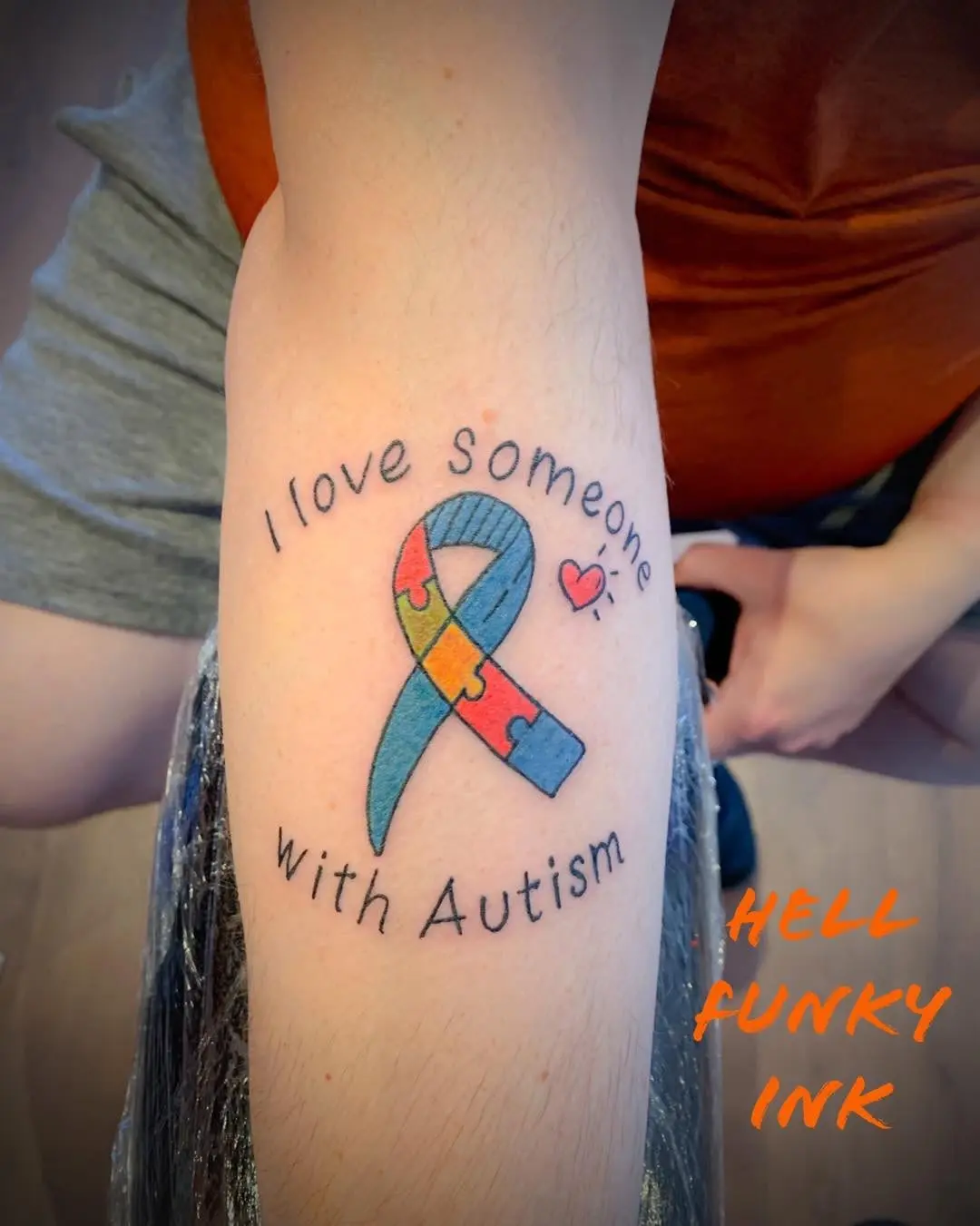 Vibrant tattoo expressing love for autism