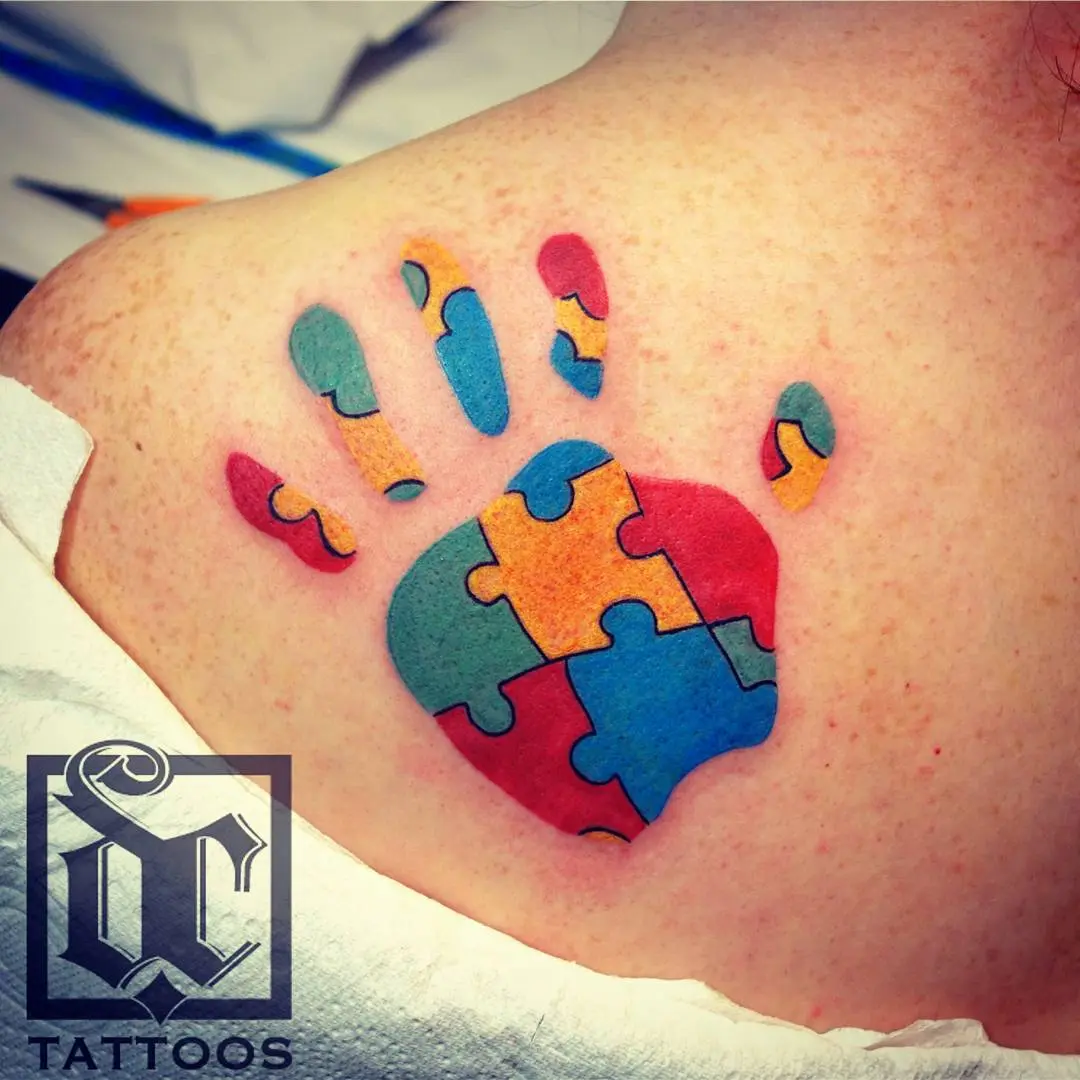 Colorful puzzle piece hand tattoo design