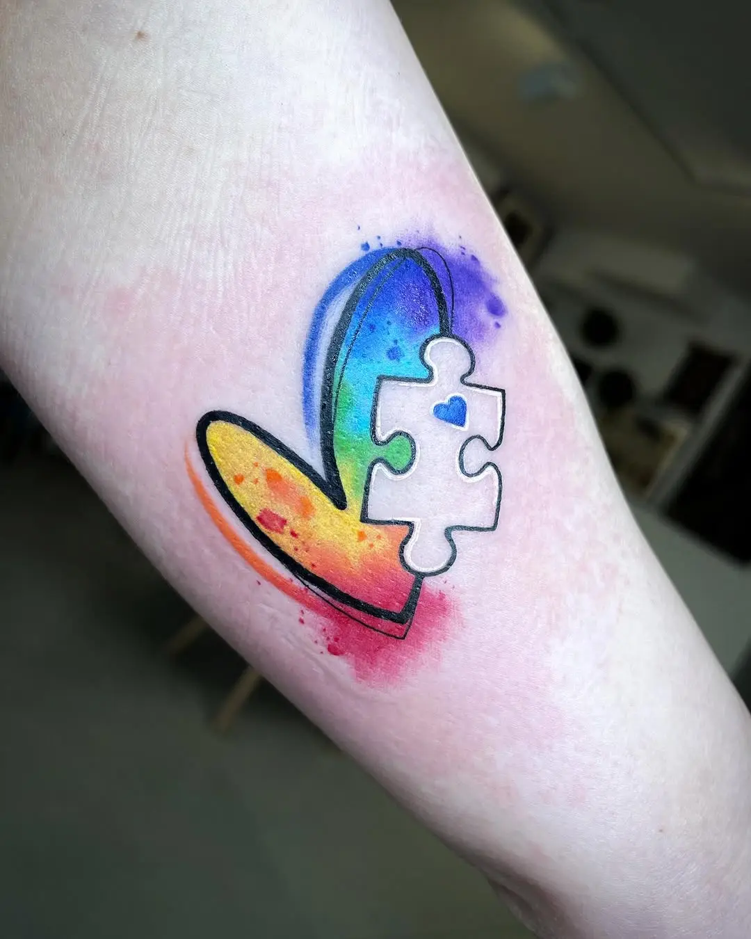 Colorful heart tattoo symbolizing autism awareness