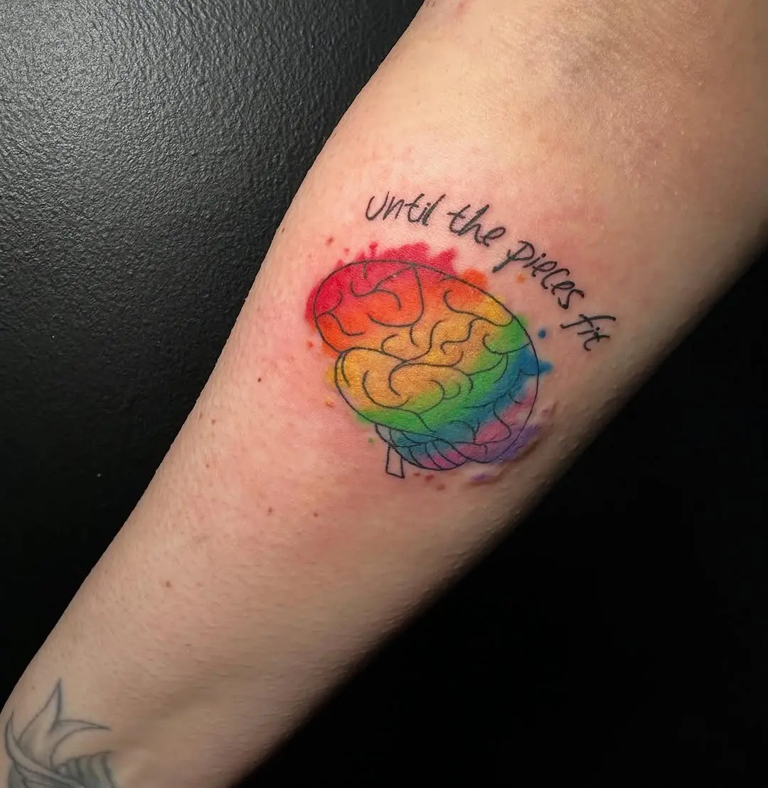 Vibrant rainbow brain tattoo with inspiring message