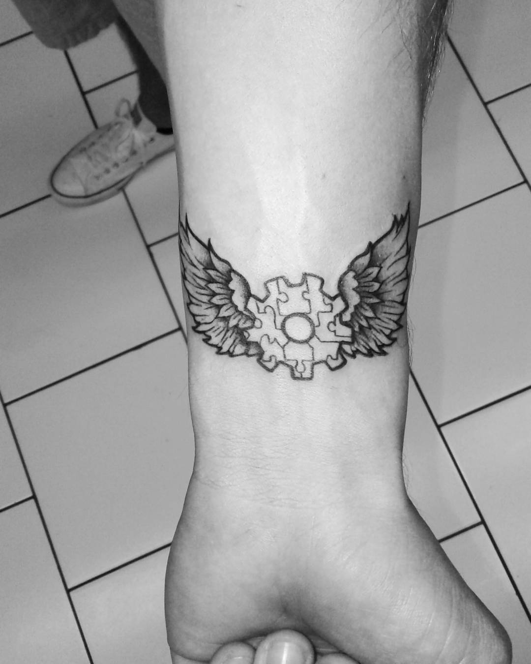 Symbolic autism tattoo with angelic wings