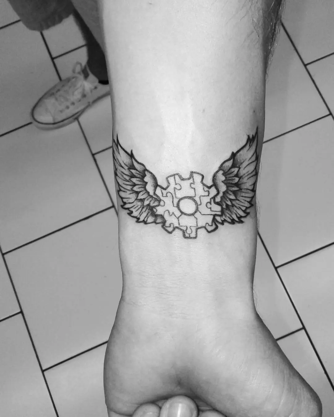 Symbolic autism tattoo with angelic wings