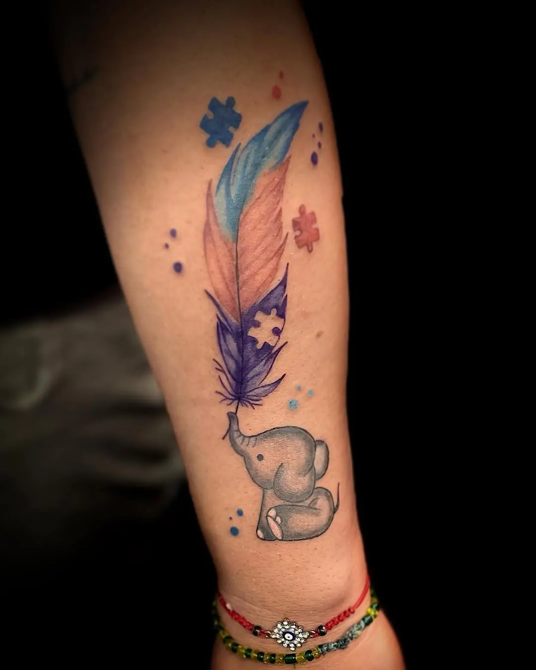Colorful elephant and feather tattoo design