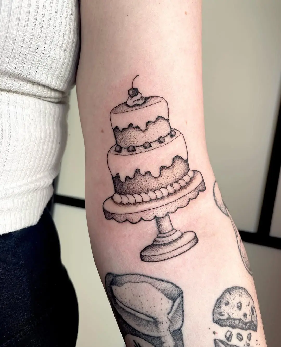 Charming cake tattoo for baking enthusiasts
