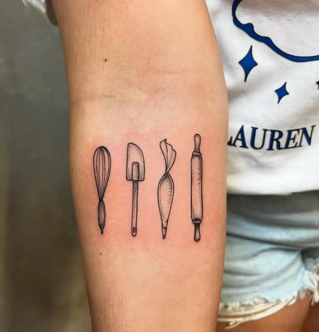 Minimalist baking tools tattoo on forearm