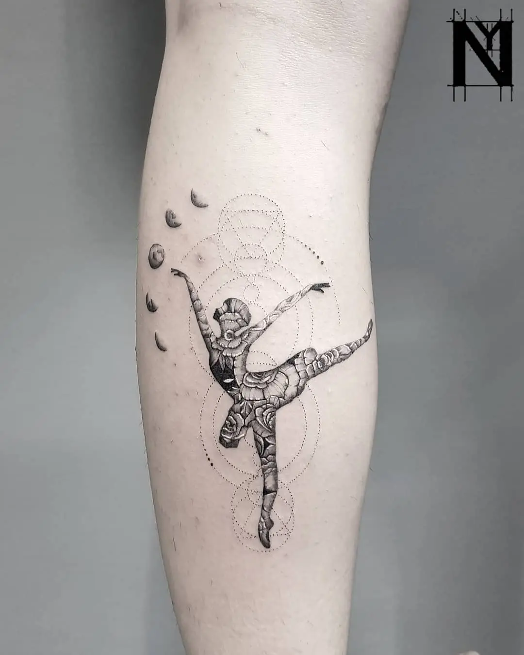 Elegant ballet dancer with cosmic elements tattoo