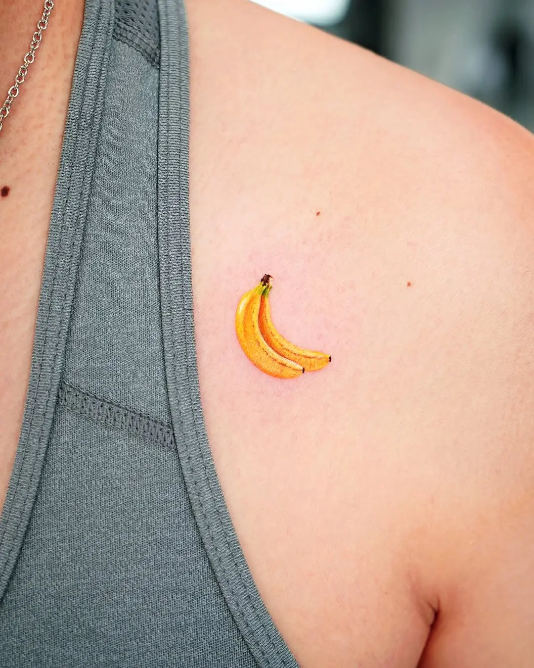 Charming banana tattoo on the upper arm