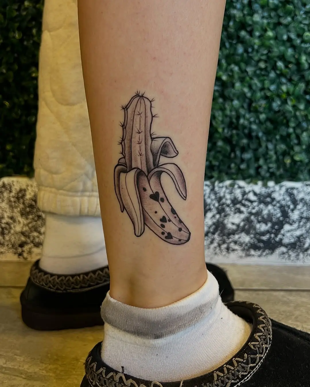 Whimsical banana tattoo with cactus details