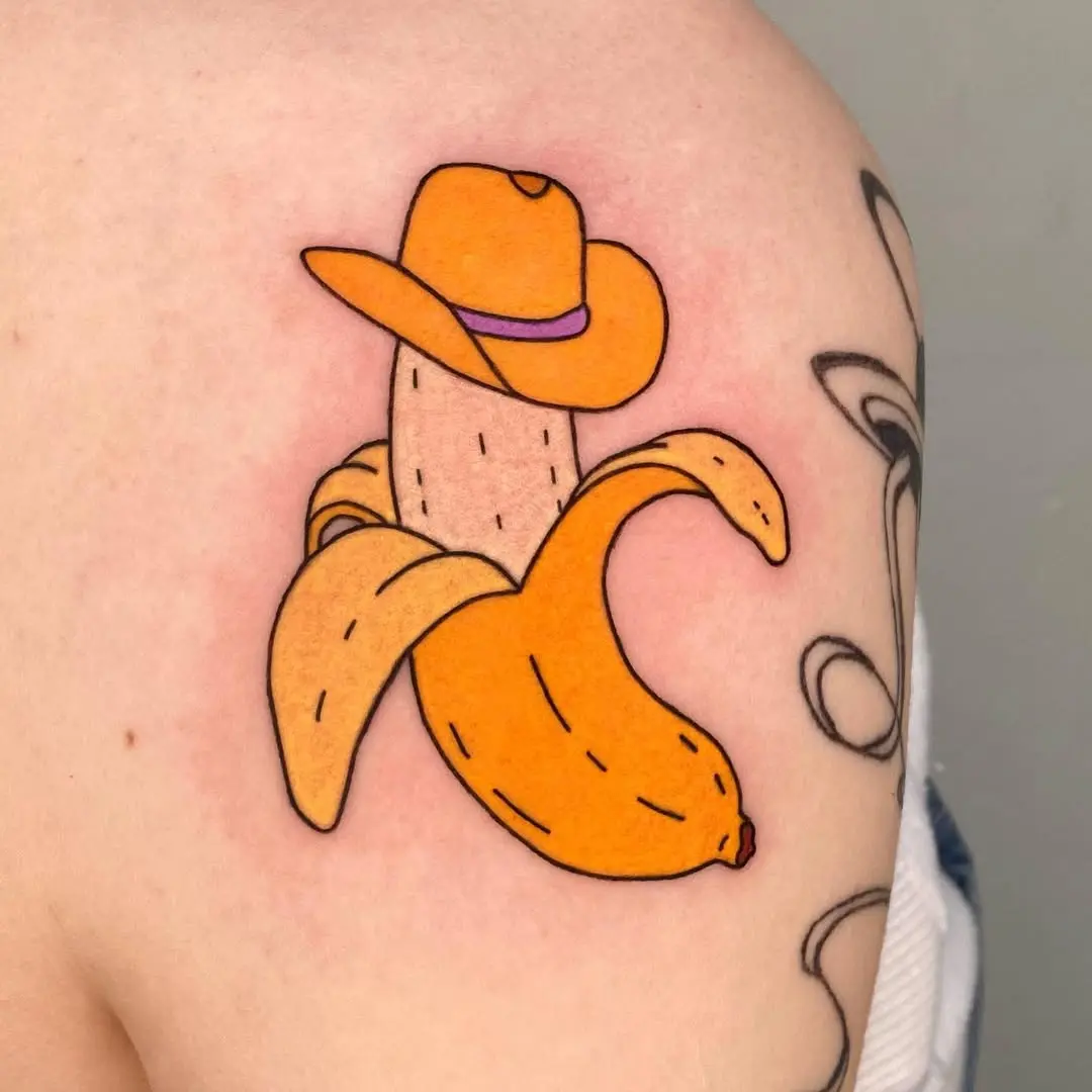 Whimsical banana tattoo with a cowboy hat