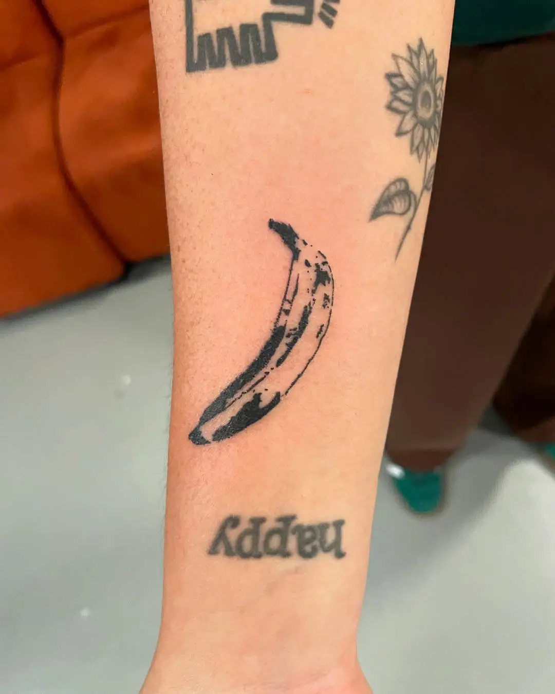 Minimalist Banana Tattoo Design on Forearm
