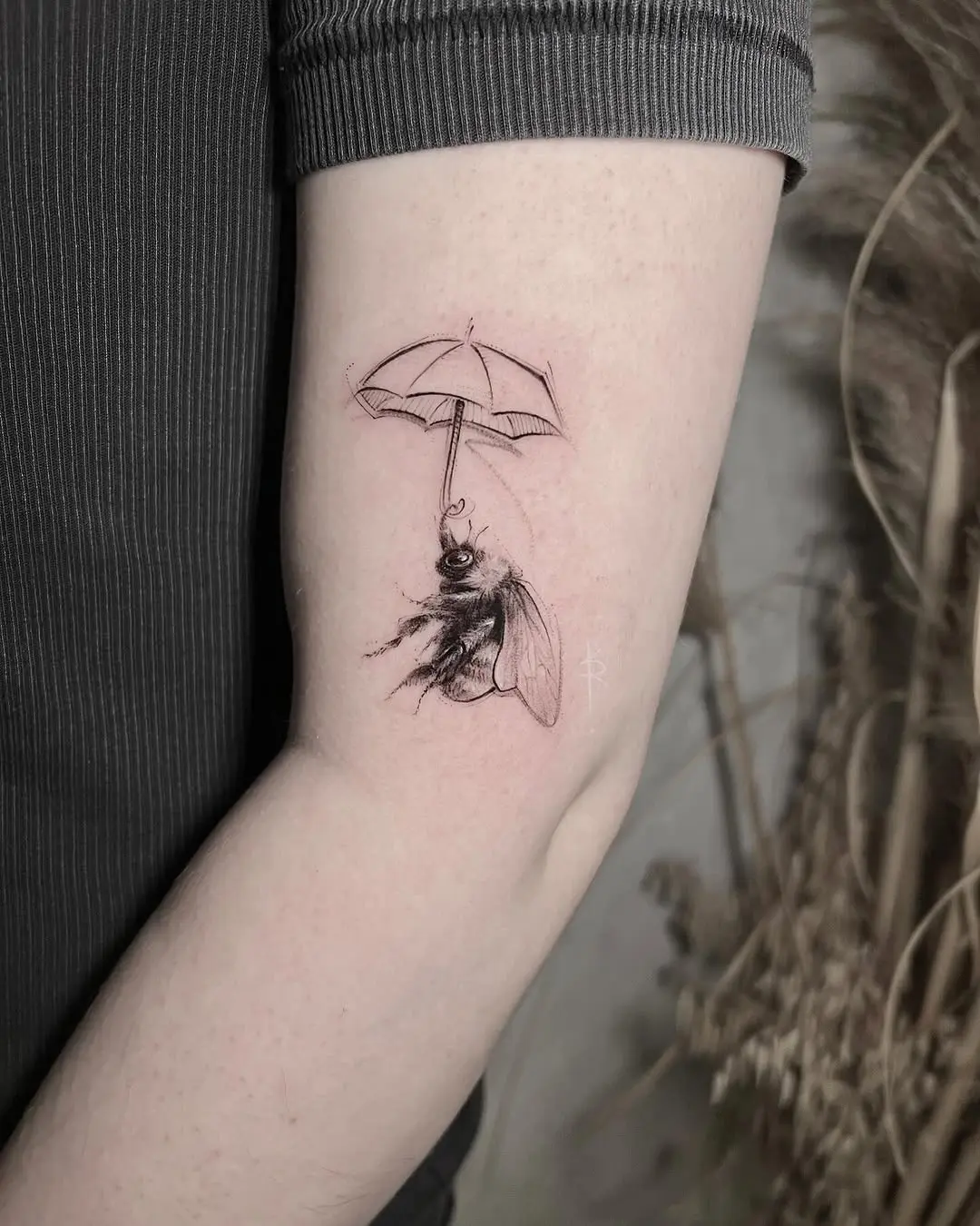 Intricate bee tattoo paired with enchanting umbrella