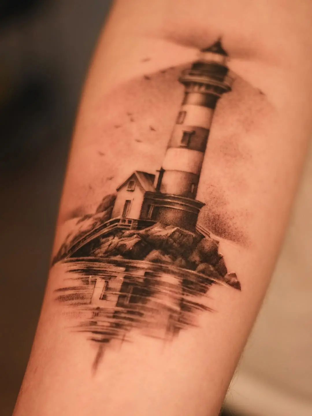 Stunning black and gray lighthouse tattoo design