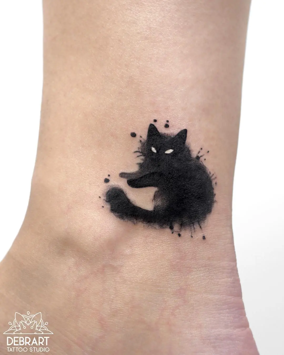 Striking minimalist black cat tattoo design