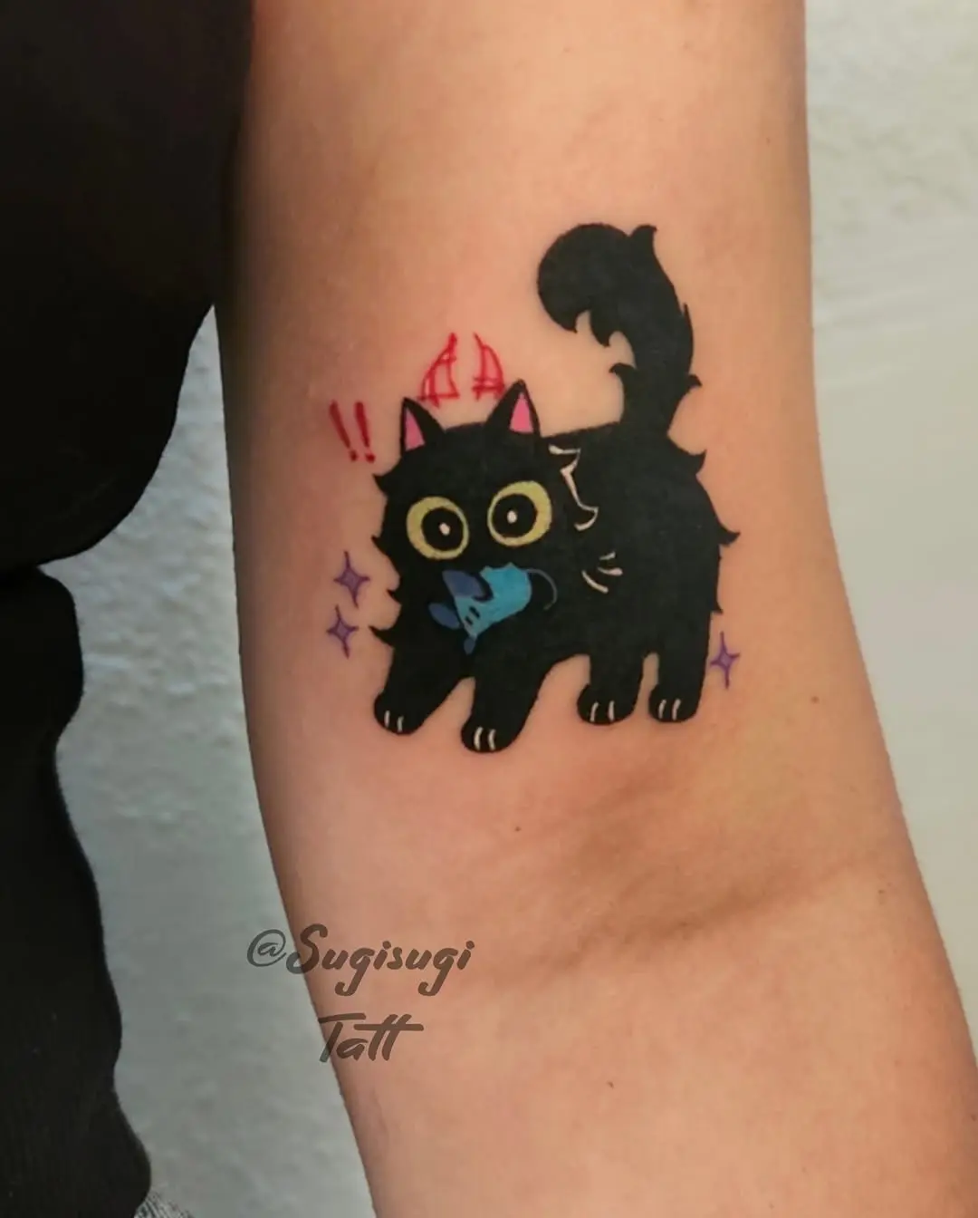 Playful black cat with colorful accents tattoo