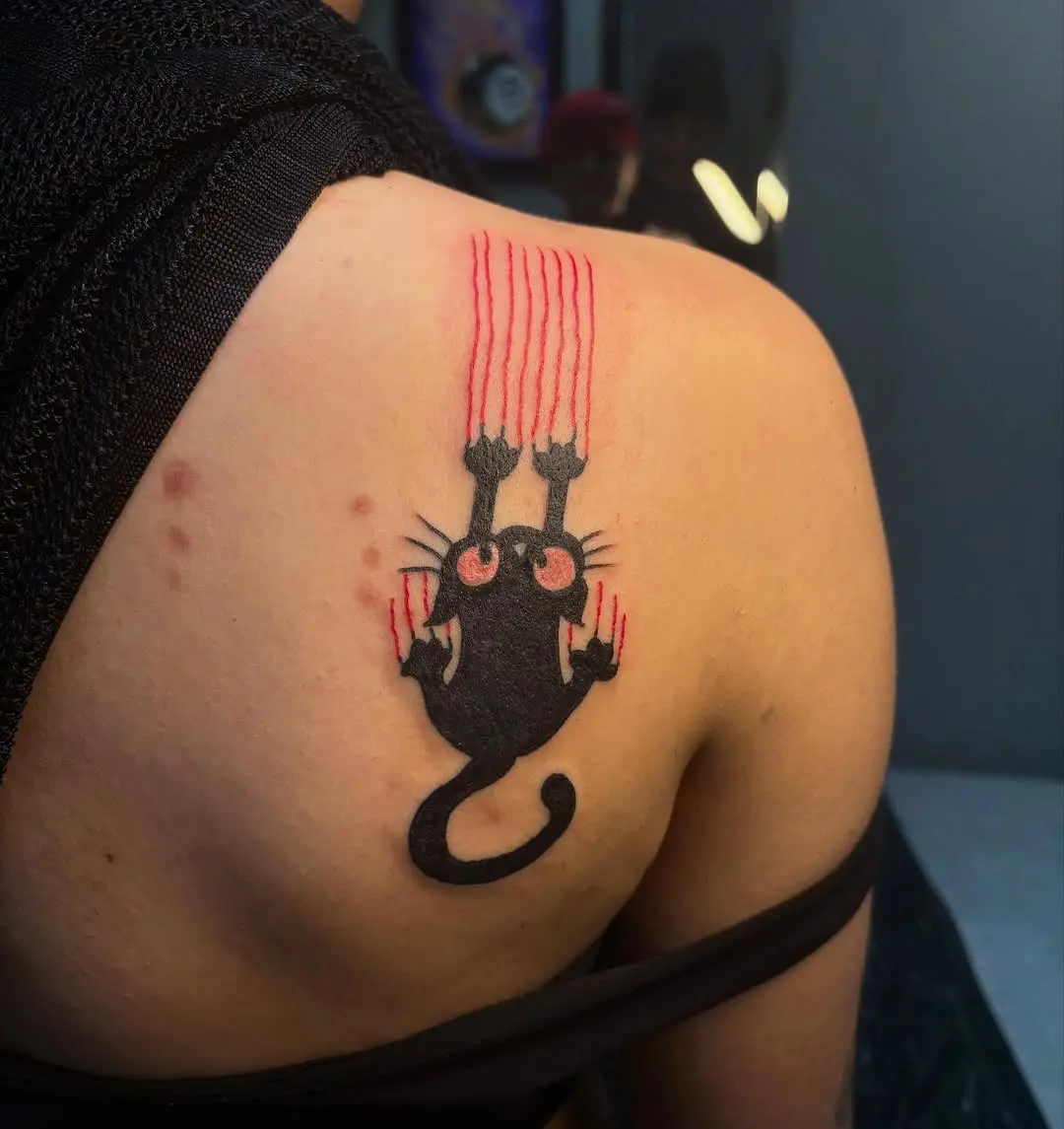 Unique black cat tattoo with striking red claws