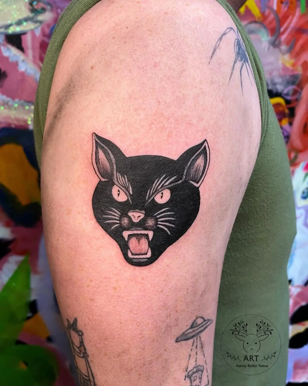Fierce black cat tattoo design on arm