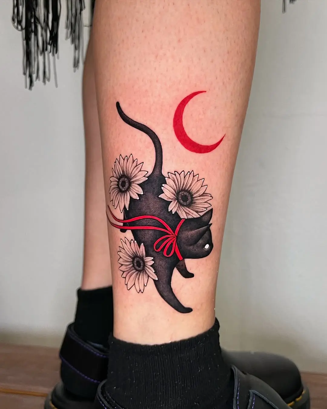 Elegant black cat tattoo with florals and moon