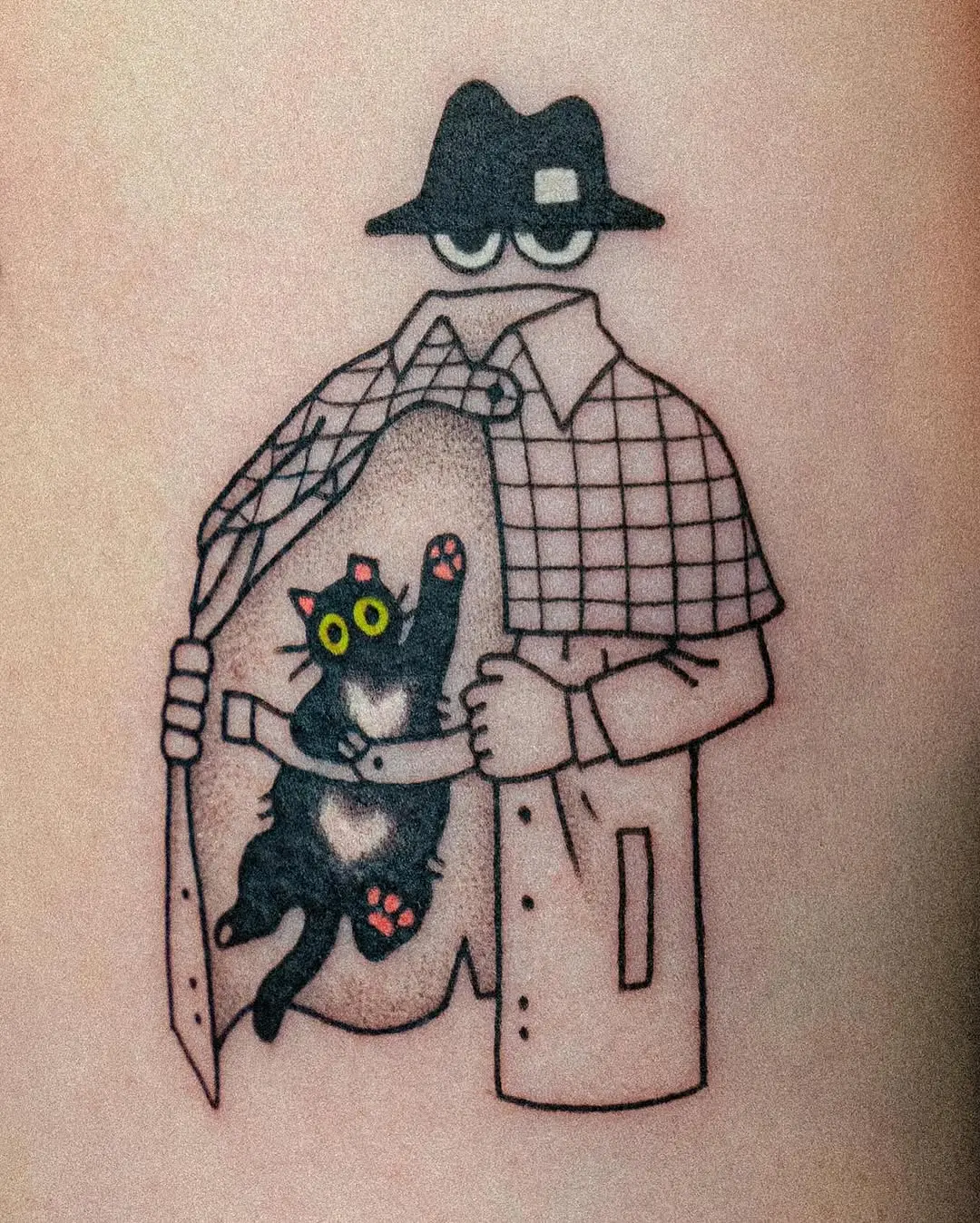 Whimsical black cat tattoo with surprising reveal