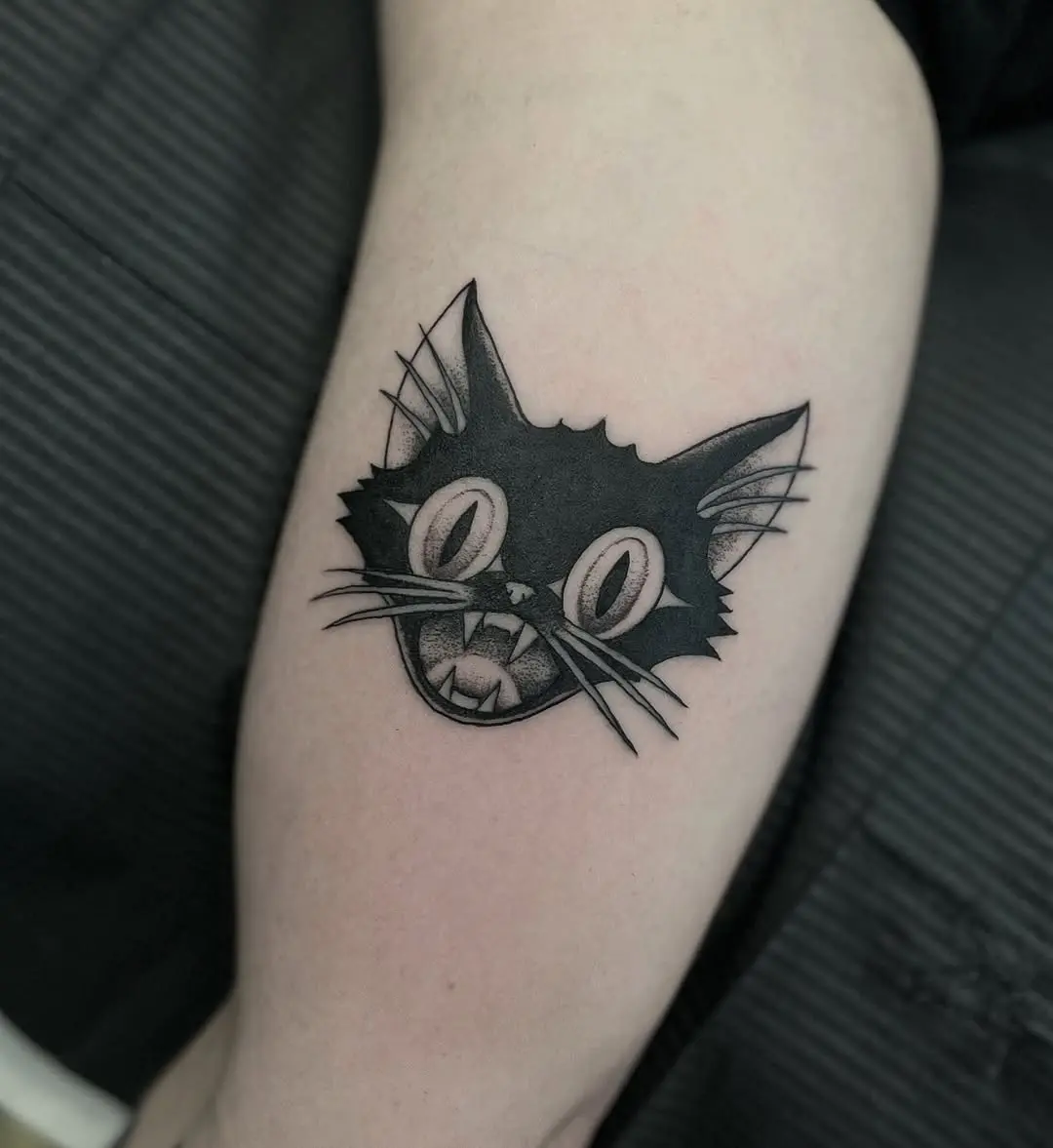 Playful black cat tattoo with striking features