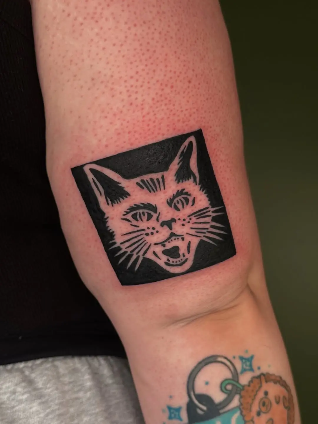 Surprised Expression in Black Cat Tattoo Design