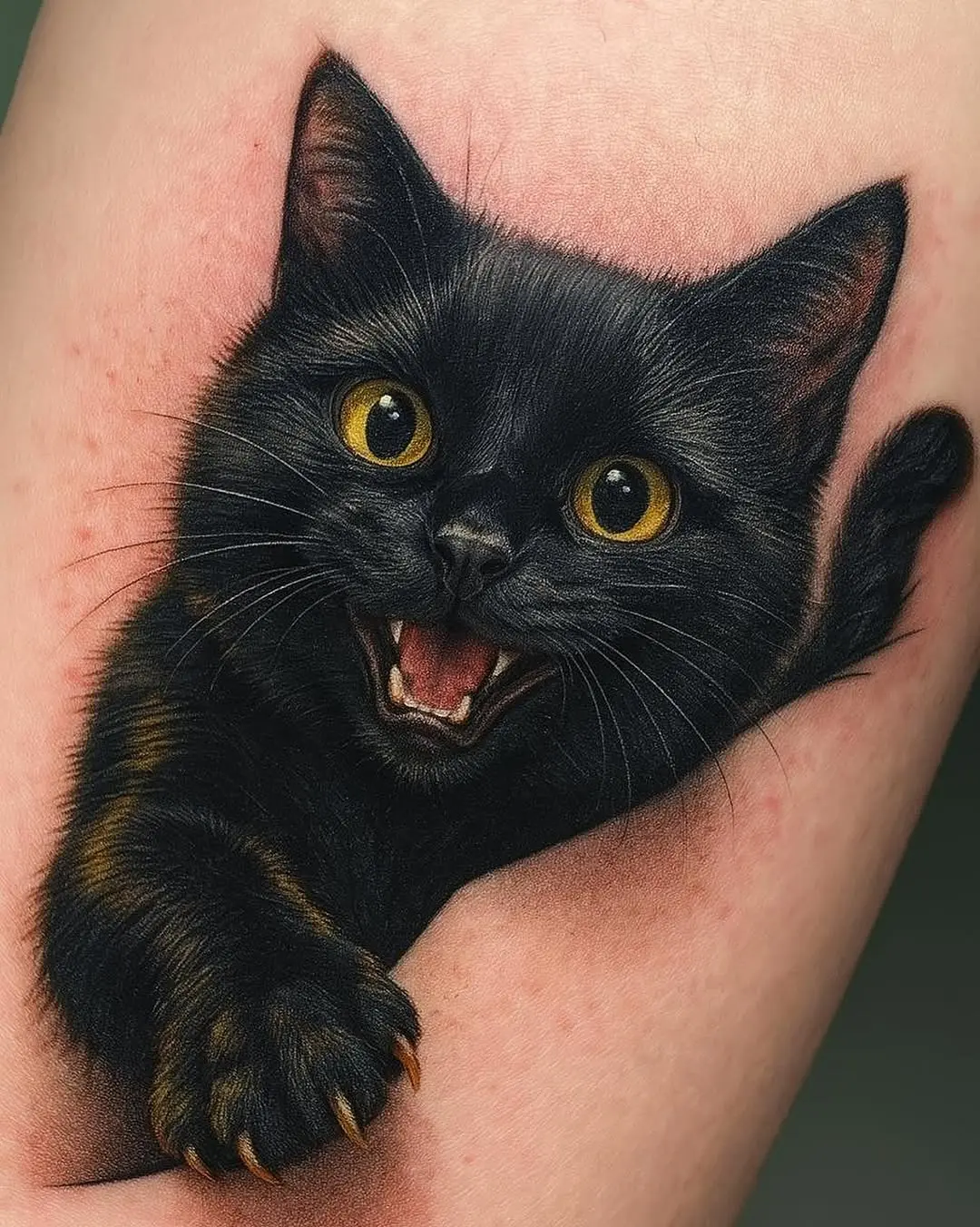 Charming black cat tattoo with lively expression