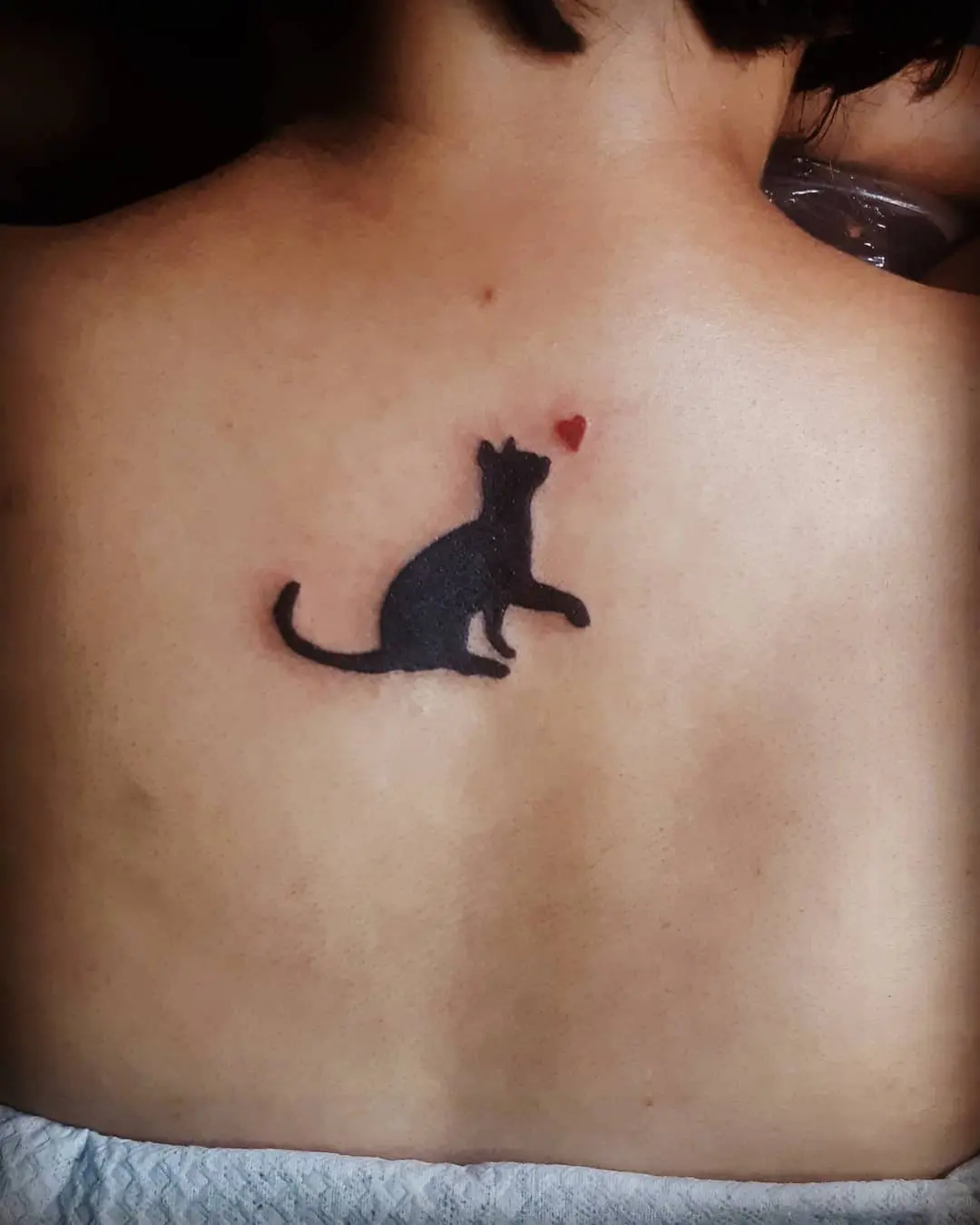 Charming silhouette of a black cat tattoo