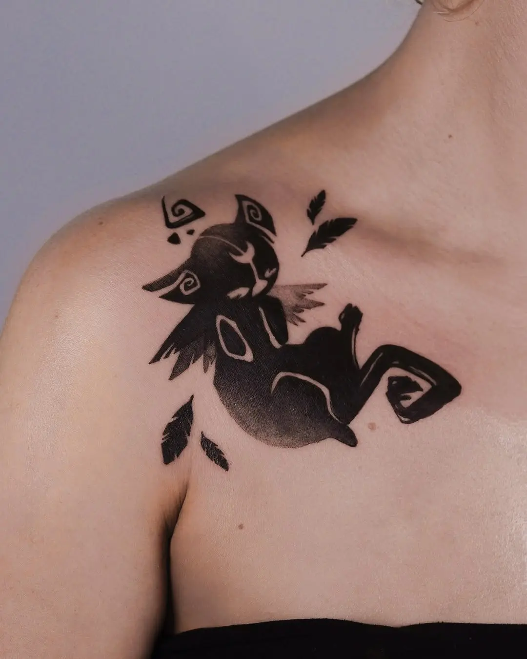 Charming Black Cat Tattoo with Feathers