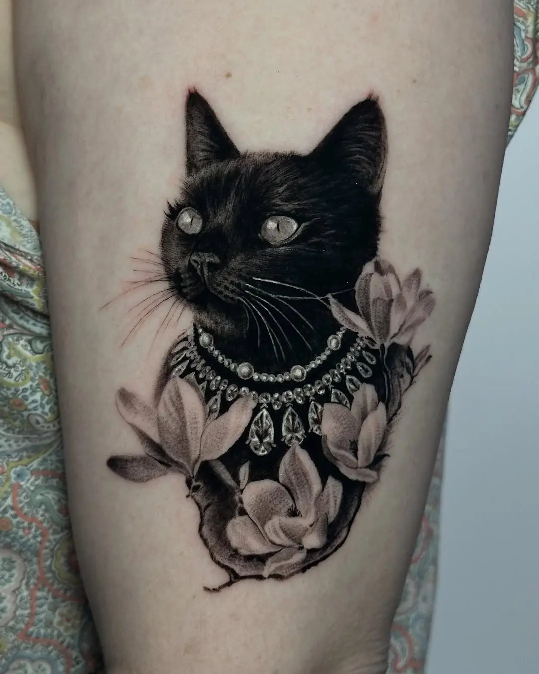 Elegant Black Cat Tattoo Surrounded by Flowers