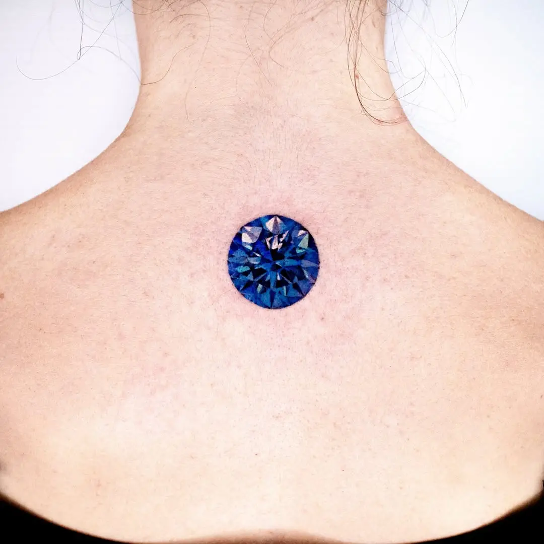 Stunning blue diamond tattoo on the neck