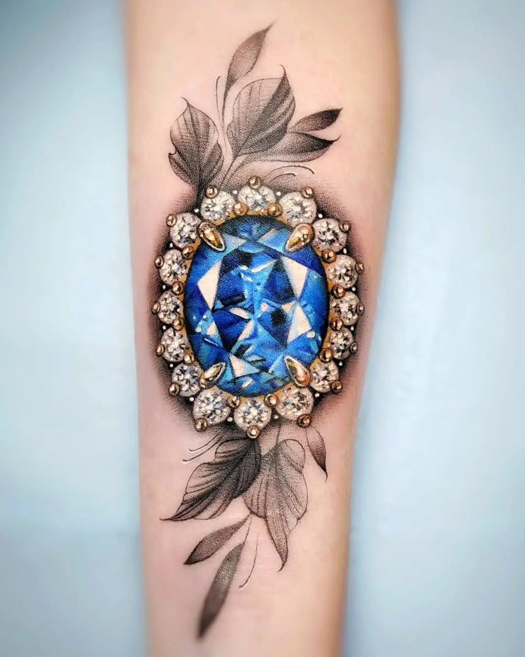 Glamorous blue diamond tattoo design with leaves