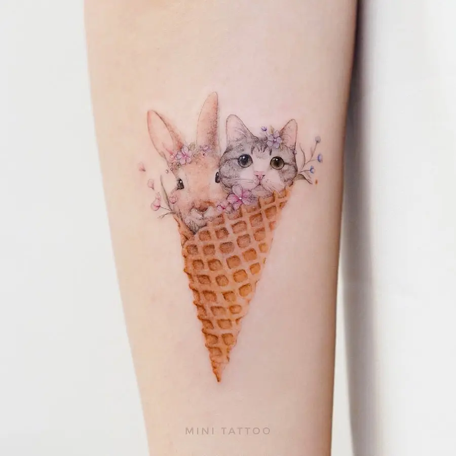 Quirky animals in an ice cream cone tattoo