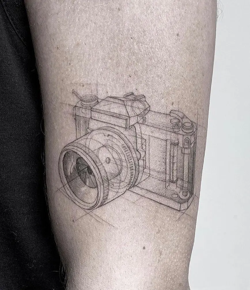 Intricate camera tattoo design with a 3D effect