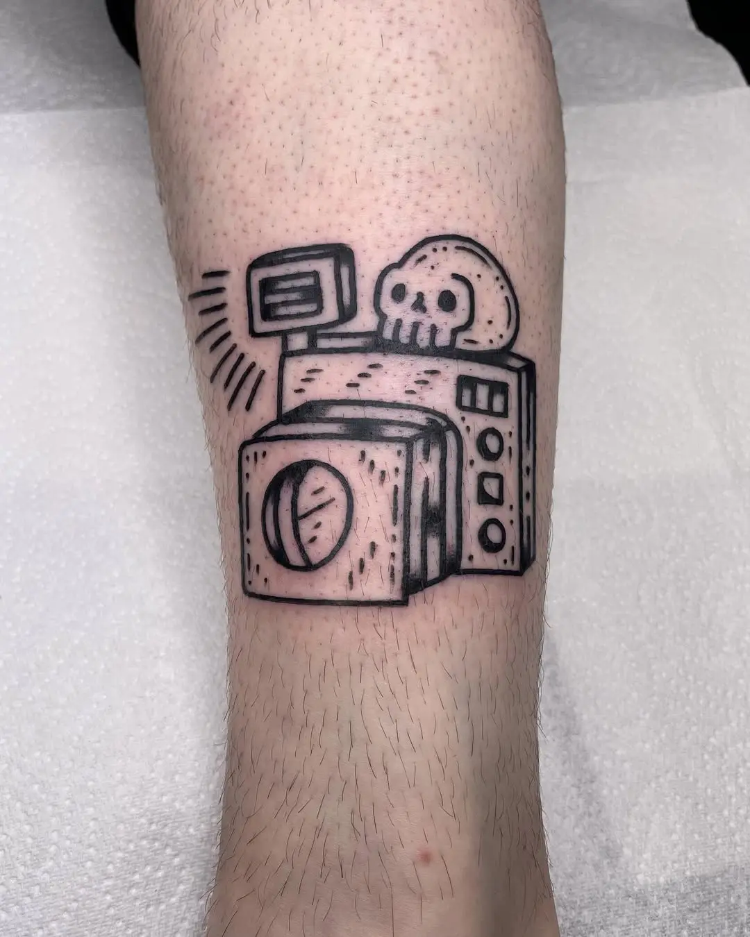 Playful skull camera tattoo design for photo lovers