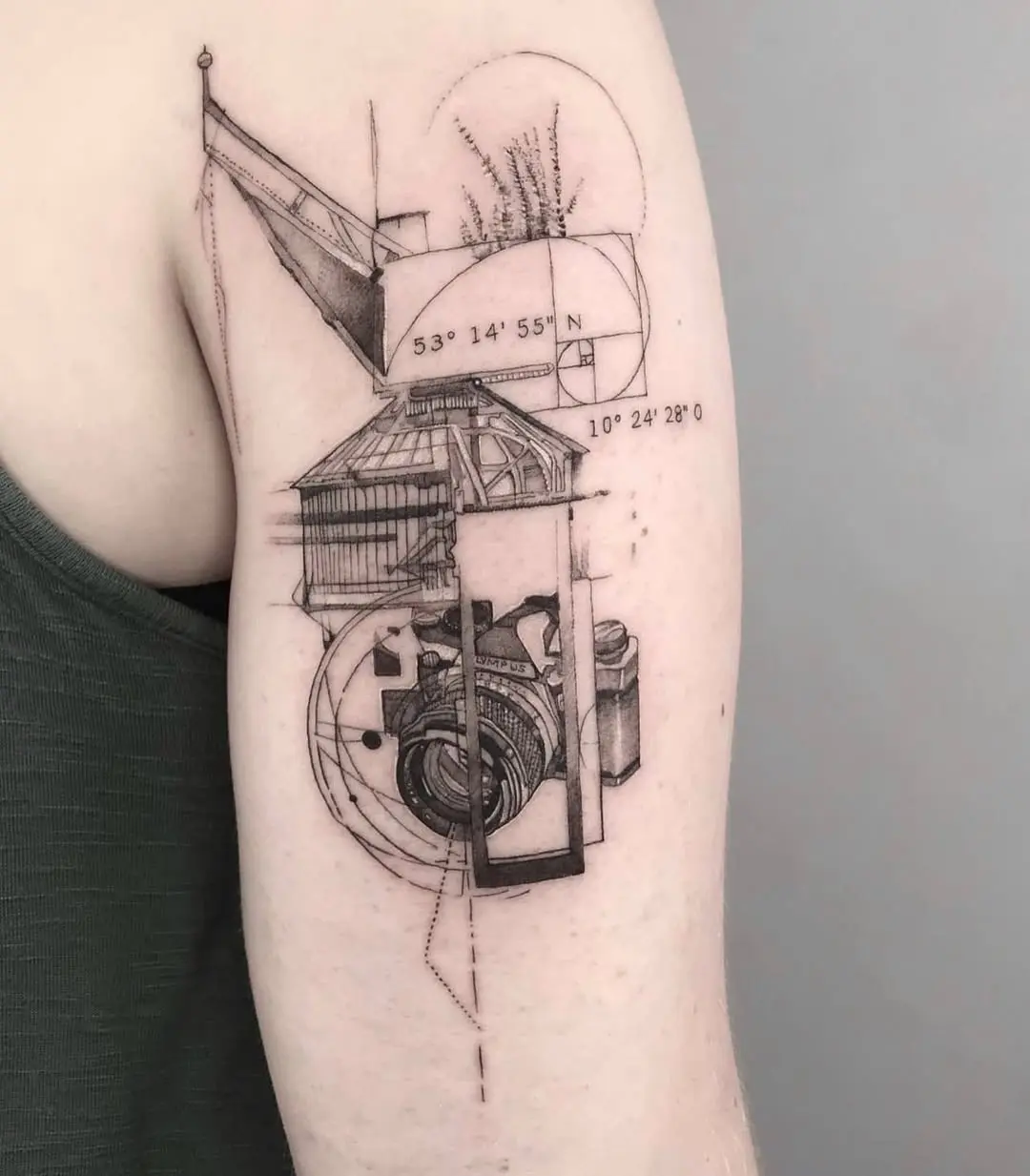 Intricate geometric camera tattoo on the arm
