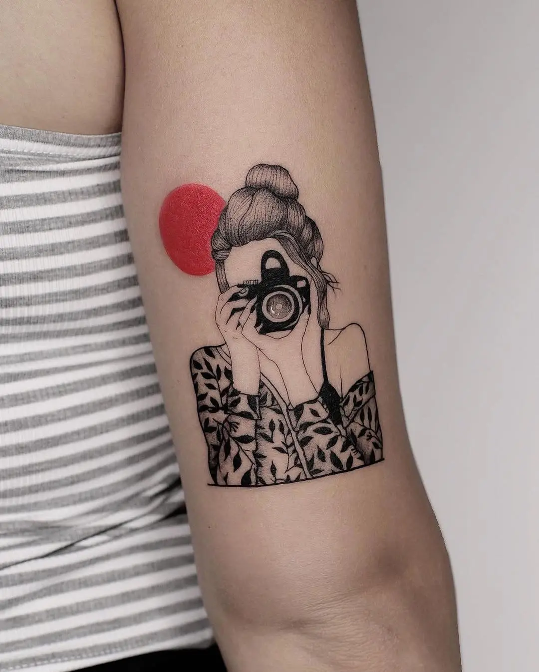Artistic Camera Tattoo with a Bold Red Circle